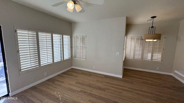 unfurnished room with ceiling fan and dark hardwood / wood-style flooring