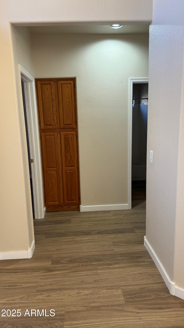 hallway with hardwood / wood-style floors