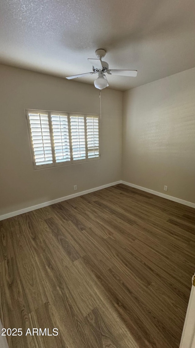 spare room featuring a textured ceiling, ceiling fan, and dark hardwood / wood-style floors