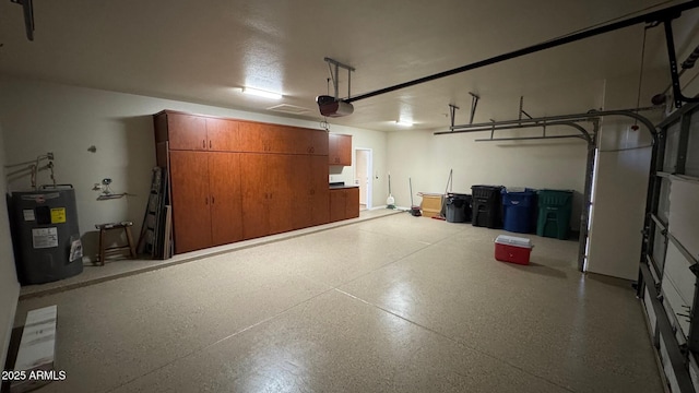 garage with a garage door opener and electric water heater