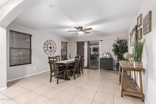 tiled dining space featuring ceiling fan