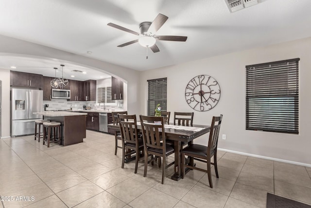 tiled dining room featuring ceiling fan