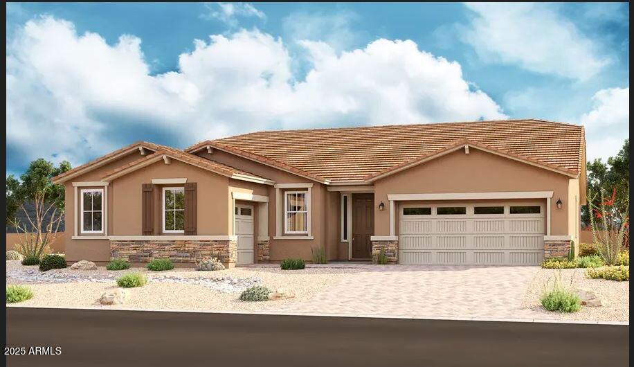 view of front facade featuring a tile roof, stucco siding, decorative driveway, stone siding, and an attached garage