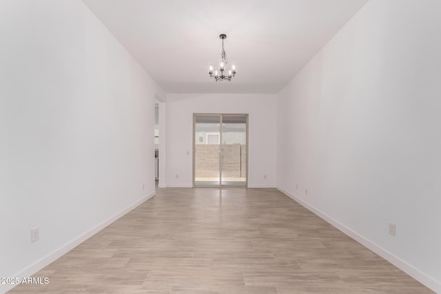20273 W Monterey Way, Buckeye, AZ 85396 - spare room featuring a chandelier and light wood-style floors