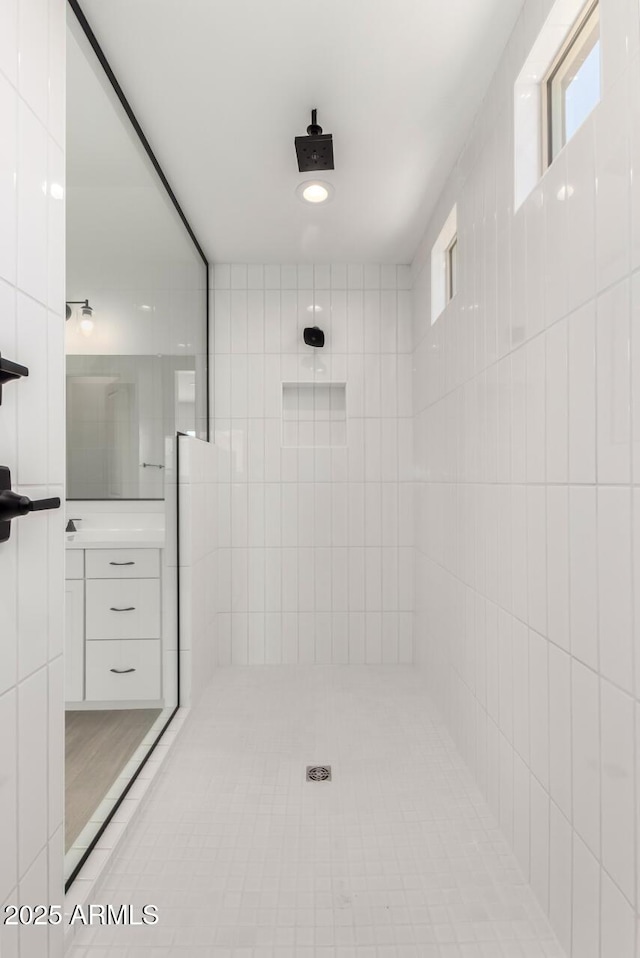 20273 W Monterey Way, Buckeye, AZ 85396 - bathroom with tiled shower, vanity, and healthy amount of natural light