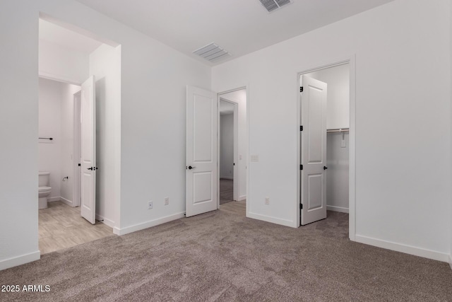 20273 W Monterey Way, Buckeye, AZ 85396 - unfurnished bedroom with carpet flooring, ensuite bathroom, and a spacious closet