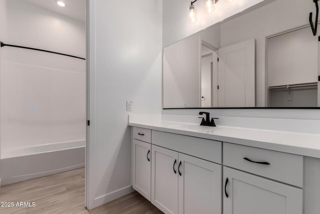 20273 W Monterey Way, Buckeye, AZ 85396 - full bath with vanity, wood finished floors, bathtub / shower combination, and recessed lighting