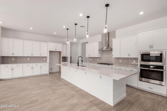 20273 W Monterey Way, Buckeye, AZ 85396 - kitchen featuring stainless steel appliances, wall chimney range hood, backsplash, light countertops, and recessed lighting