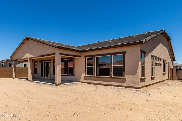 20273 W Monterey Way, Buckeye, AZ 85396 - rear view of property with stucco siding and a patio