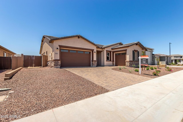 20273 W Monterey Way, Buckeye, AZ 85396 - single story home featuring a garage, decorative driveway, stucco siding, and a gate