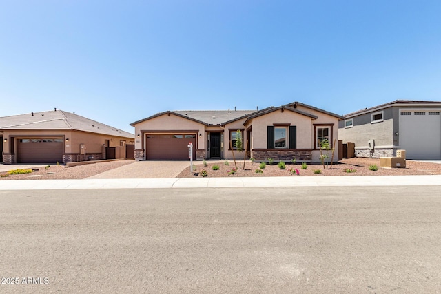 20273 W Monterey Way, Buckeye, AZ 85396 - single story home with stone siding, stucco siding, driveway, and an attached garage