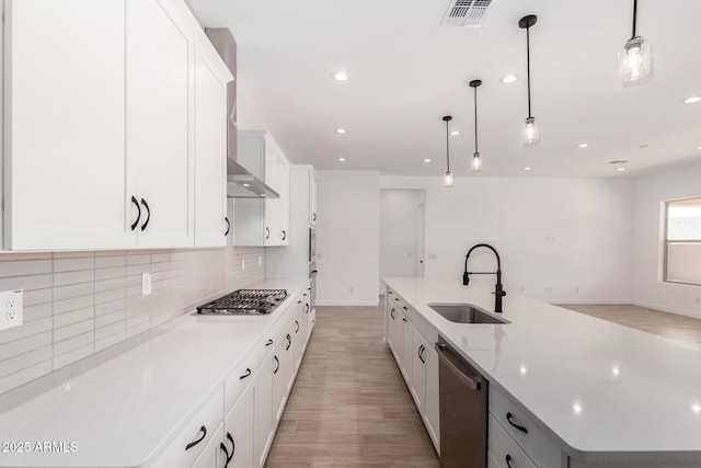 20273 W Monterey Way, Buckeye, AZ 85396 - kitchen with appliances with stainless steel finishes, backsplash, a spacious island, light wood-style flooring, and white cabinets