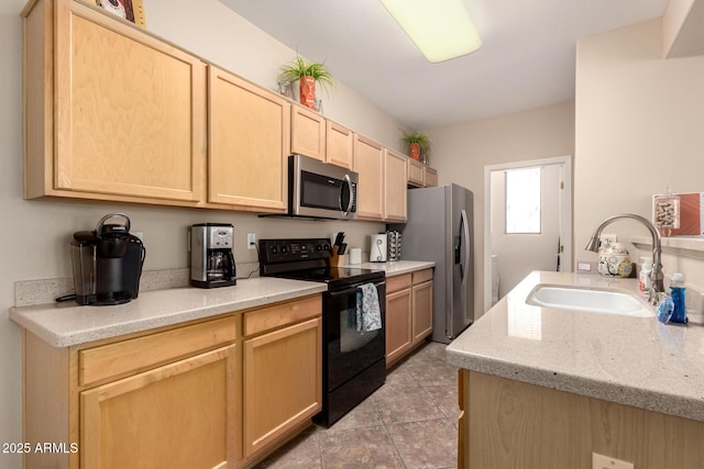 kitchen featuring light stone counters, light tile patterned flooring, light brown cabinets, stainless steel appliances, and a sink