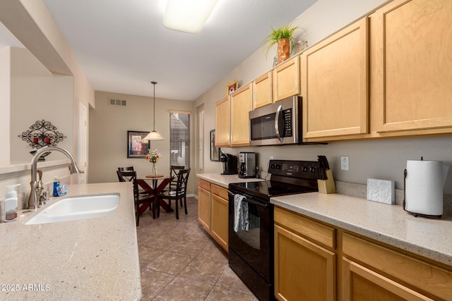 kitchen featuring stainless steel microwave, electric range, light brown cabinetry, a sink, and light stone countertops