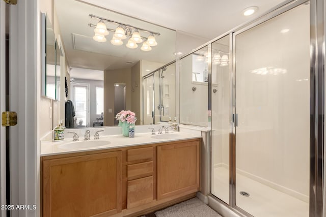 bathroom with double vanity, a sink, and a shower stall