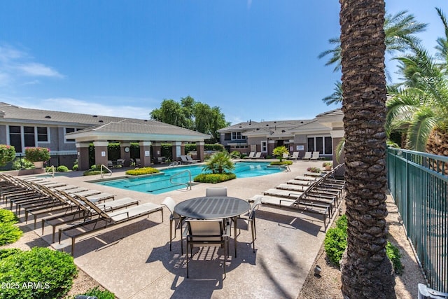 community pool featuring a gazebo, fence, and a patio