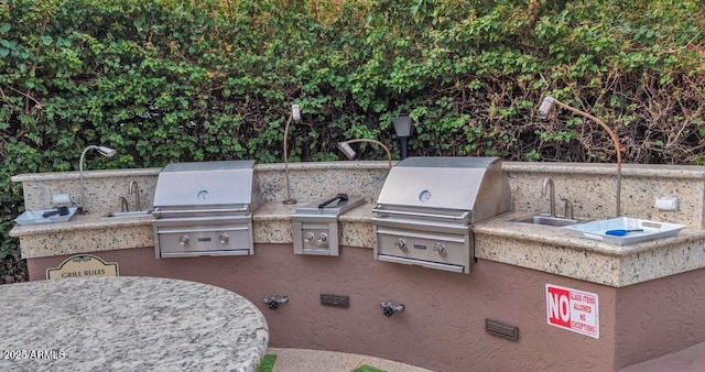 view of patio / terrace with a sink, area for grilling, and a grill