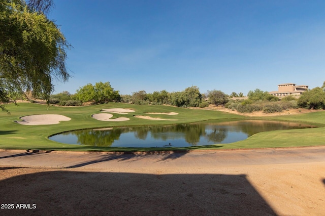 view of home's community featuring a water view, golf course view, and a yard