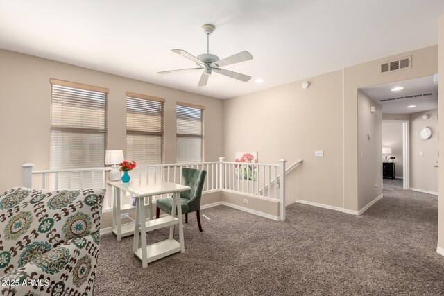 office space with carpet floors, baseboards, visible vents, and a ceiling fan