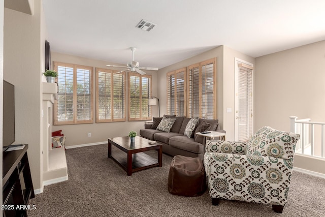 carpeted living area with visible vents, ceiling fan, and baseboards