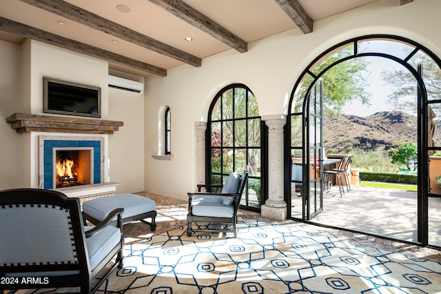 view of patio featuring an AC wall unit, a tiled fireplace, a mountain view, and a bar