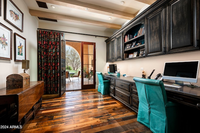 office with beam ceiling, built in desk, dark hardwood / wood-style floors, and french doors