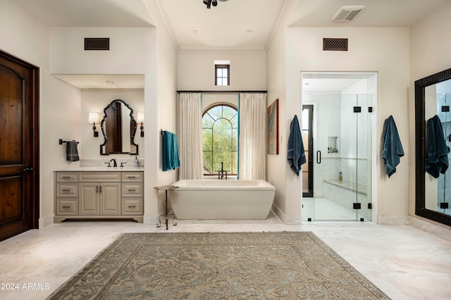 bathroom with vanity and shower with separate bathtub