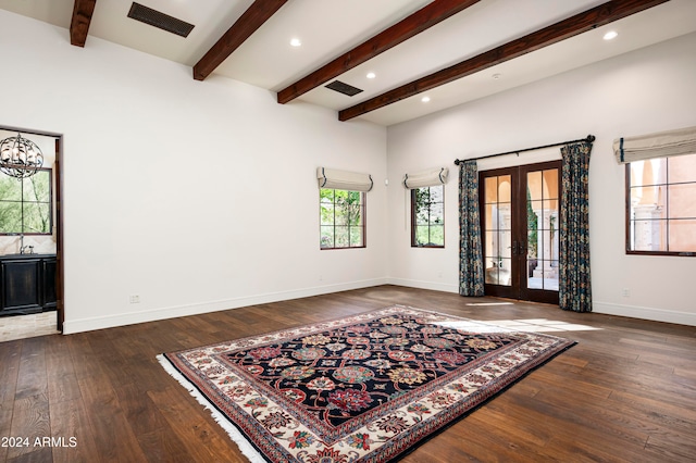 interior space featuring beam ceiling, dark wood-type flooring, and french doors