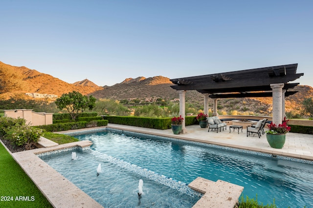 view of pool with a mountain view, a patio area, and a pergola