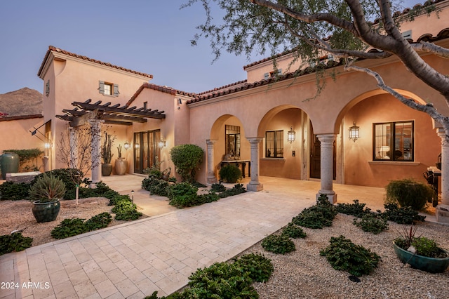 mediterranean / spanish-style home featuring a patio