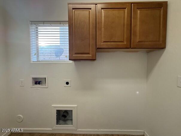 laundry room featuring gas dryer hookup, cabinets, hookup for an electric dryer, and hookup for a washing machine