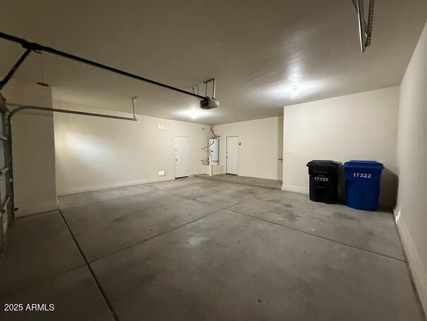 garage with a garage door opener and water heater