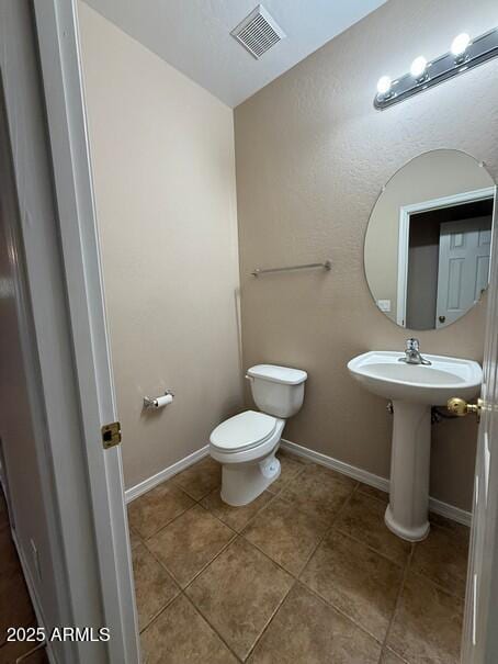 bathroom featuring sink, tile patterned floors, and toilet