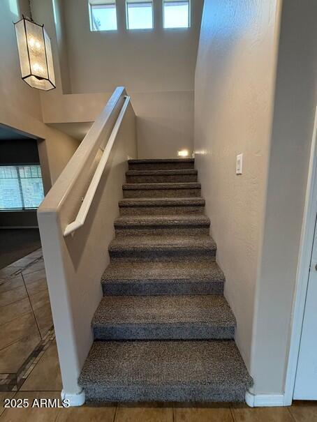 stairway with tile patterned floors