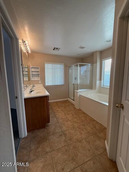 bathroom featuring independent shower and bath, vanity, tile patterned flooring, and a textured ceiling