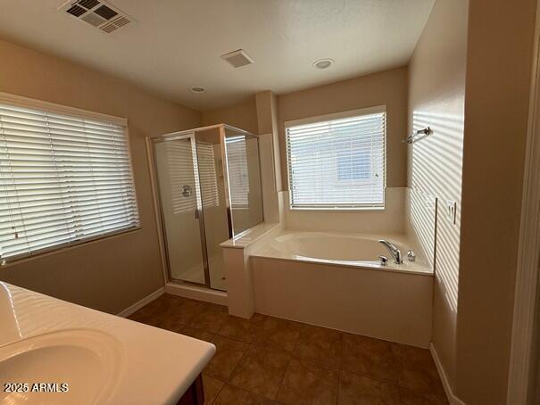 bathroom featuring vanity, tile patterned floors, and independent shower and bath