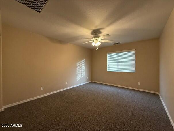 carpeted empty room with ceiling fan