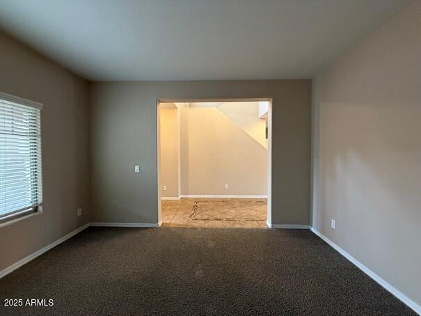 carpeted spare room featuring plenty of natural light