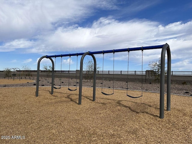 view of property's community with playground community and fence