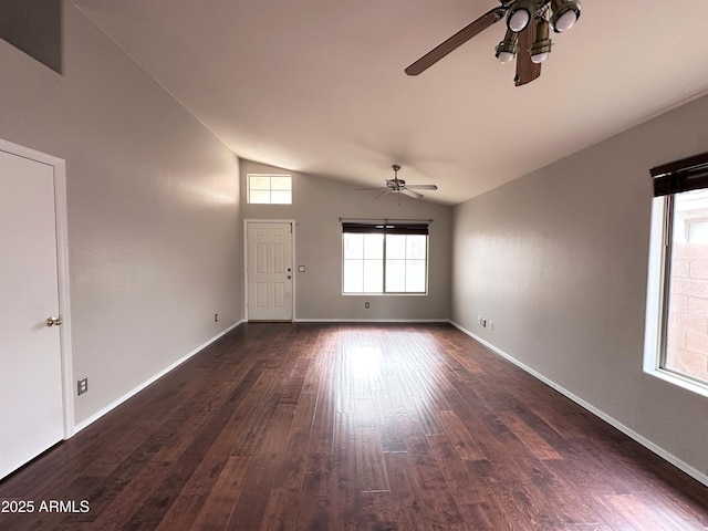 empty room with dark wood-type flooring, ceiling fan, and lofted ceiling