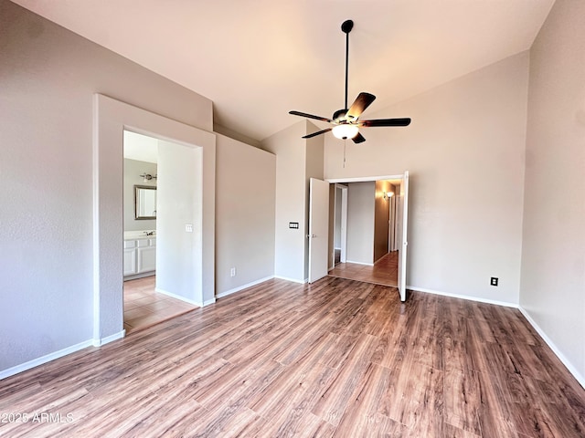 unfurnished room with ceiling fan, vaulted ceiling, and light hardwood / wood-style floors