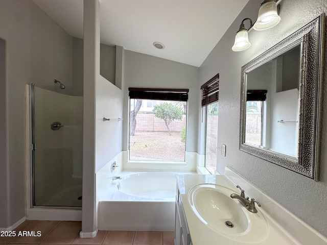 bathroom with lofted ceiling, tile patterned floors, separate shower and tub, and vanity