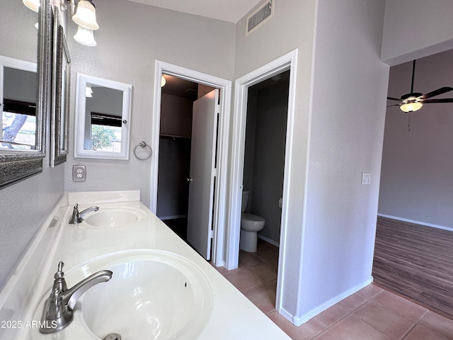 bathroom featuring ceiling fan, tile patterned floors, vanity, and toilet