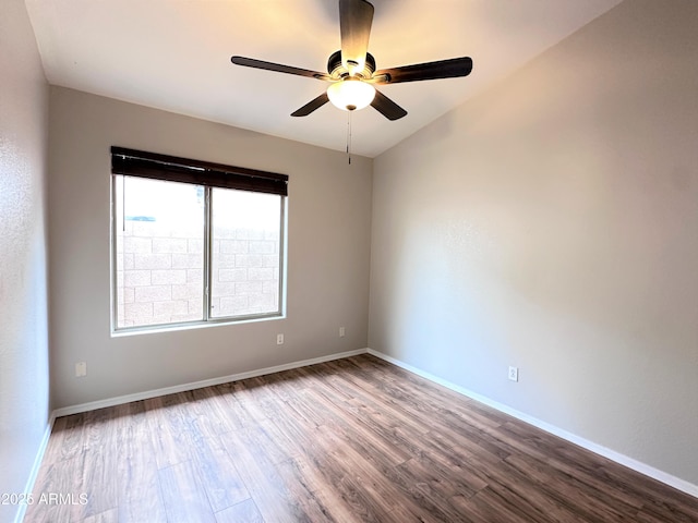 unfurnished room with ceiling fan, lofted ceiling, and wood-type flooring