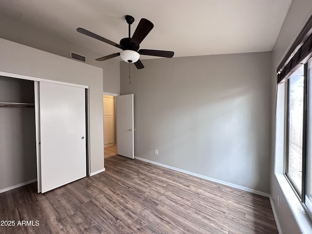 unfurnished bedroom with ceiling fan, a closet, and wood-type flooring