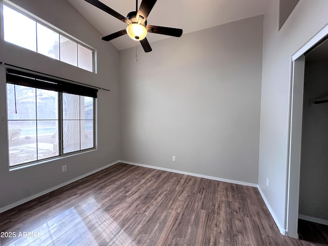 spare room featuring hardwood / wood-style flooring, ceiling fan, and vaulted ceiling