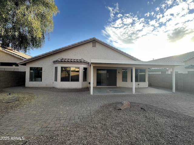 back of property featuring a patio area