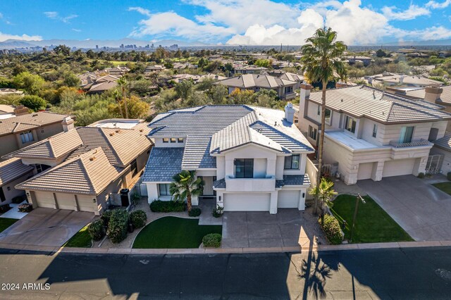 townhome / multi-family property with a front yard and a garage