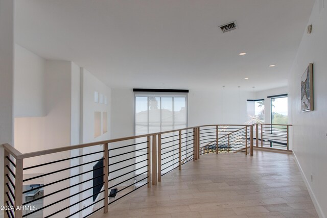 bedroom featuring light hardwood / wood-style floors, access to outside, and a notable chandelier