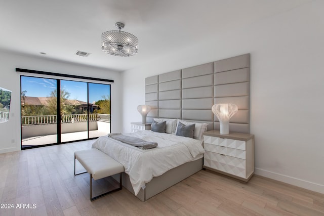 bedroom with light hardwood / wood-style flooring and access to exterior